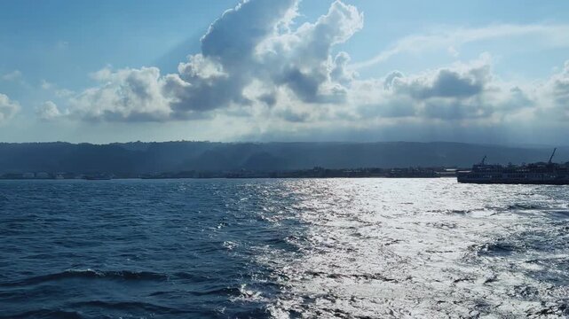 Bali, Indonesia - August 27, 2025: Car and passenger ferries cross the Bali Strait from Gilimanuk Harbor to Ketapang Harbor. View of the strait from the ferry deck. 4К