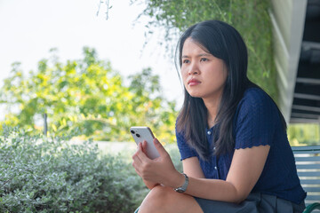 Asian woman feeling frustrated or upset, dark side of technology, modern life, hustle culture. Sad,...