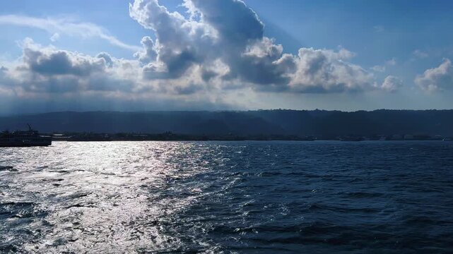 Bali, Indonesia - August 27, 2025: Car and passenger ferries cross the Bali Strait from Gilimanuk Harbor to Ketapang Harbor. View of the strait from the ferry deck. 4К