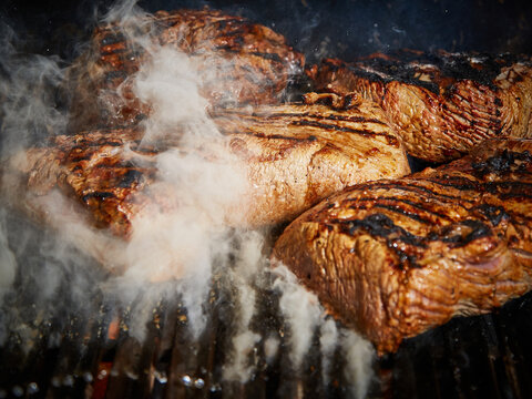 Juicy Grilled Steak with Smoke and Char Marks on Barbecue Grill