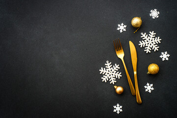 Christmas table setting with plate, cutlery and christmas decorations on white background.