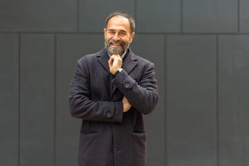 Smiling mature businessman showing confidence and positive thinking