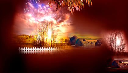 Idyllic rural landscape scene with a vibrant sunset illuminating a picturesque hayfield and fence