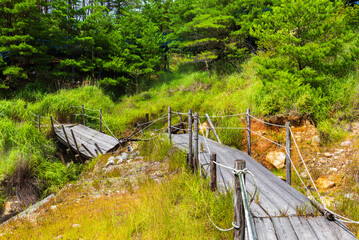 Several views of the Hell of Kumatsu (Komatsujigoku), where a wooden path leads you through a collection of boiling mud pools and steamy fumaroles demonstrating the volcanic activity taking place just