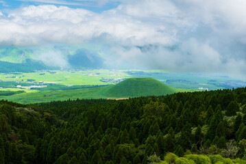 Lush green hillsides around Mt. Aso close to Nakadake Crater with views on the cone of Komezuka crater and other peaks, Kumamoto, Japan