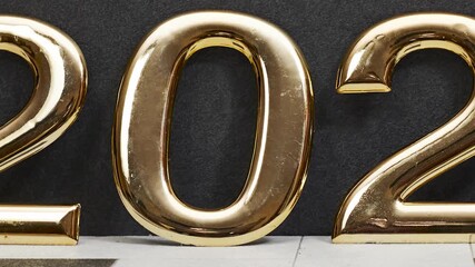 golden 2026 numerals stand on a tiled surface against a dark backdrop, creating festive New Year vibes and a premium celebratory feel suitable for events, marketing, and branding visuals