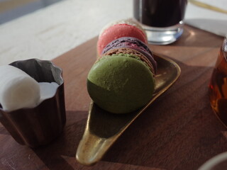 Macarons and coffee on wooden table