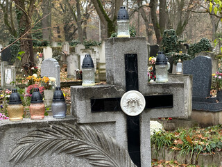 Stone cross on the tombstone in the public cemetery
