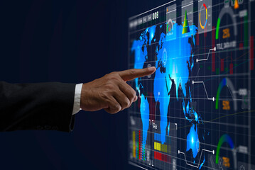 Businessman hand pointing at glowing business Invest economy chart financial world map on virtual screen. Stock, market and trade concept.  invest, marketing, growth, opportunity, analysis