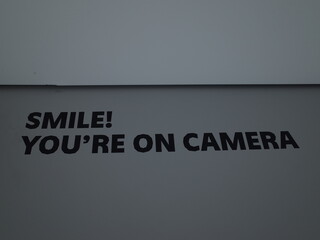 Smile you're on camera wall sign