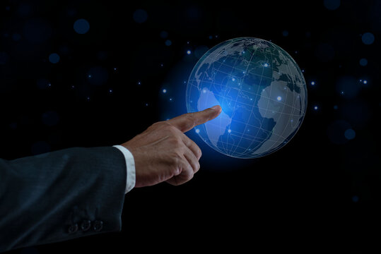 Businessman pointing glowing digital Earth globe on a virtual screen. Big data analytics and business intelligence concept. Worldwide communication. Business Internet Technology Concept.