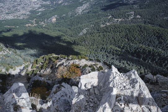 Mountains covered with green pine forest and white cliffs in the foreground. View from Mount Babadag in Oludeniz, Turkey, towards the villages of Hisar&ouml;n&uuml; and Ovacık.