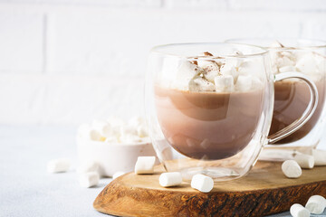 Christmas hot chocolate or cocoa with marshmallow on white with christmas decorations.