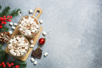 Christmas hot chocolate or cocoa with marshmallow on white with christmas decorations.