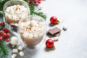 Christmas hot chocolate or cocoa with marshmallow on white with christmas decorations.