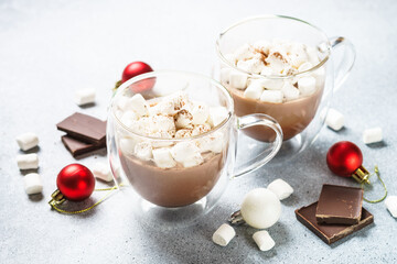 Christmas hot chocolate or cocoa with marshmallow on white with christmas decorations.