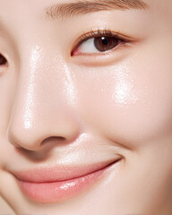 Fototapeta premium A close-up of a smiling person with glowing skin, highlighting their eyes and smooth complexion.