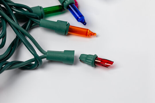 Broken bulb in Christmas string lights. Holiday lighting repair, safety and decoration concept