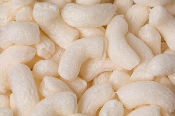 Closeup of foam packing peanuts. Shipping peanuts recycling, disposal and biodegradable packaging material concept.