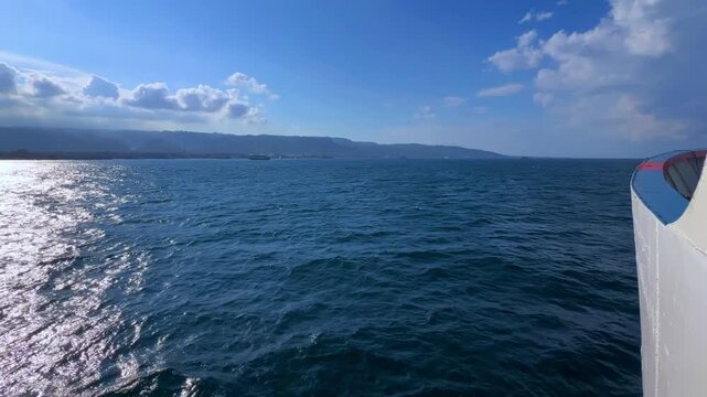 Bali, Indonesia - August 27, 2025: Car and passenger ferries cross the Bali Strait from Gilimanuk Harbor to Ketapang Harbor. View of the strait from the ferry deck. 4К