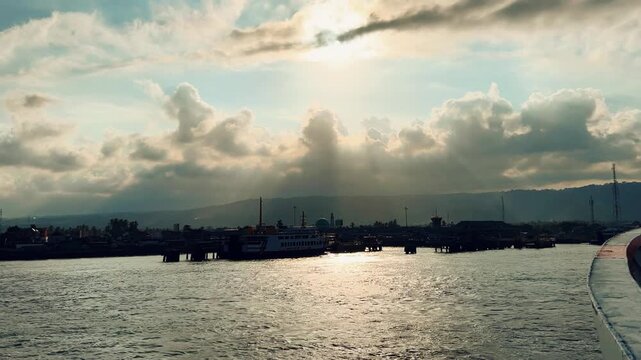 Bali, Indonesia - August 27, 2025: Car and passenger ferries cross the Bali Strait from Gilimanuk Harbor to Ketapang Harbor on the island of Java. View of the strait from the ferry deck. 4K