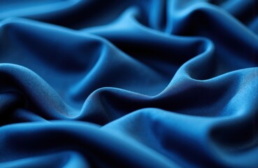 Obraz premium Smooth blue satin fabric with soft folds and shiny surface for elegant textile or fashion design