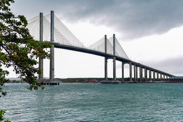 Newton Navarro cable-stayed bridge in Natal, Brazil, rising above a preserved mangrove swamp and dry vegetation, contrast between infrastructure and environment, horizontal, Newton Navarro bridge