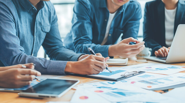 Business team analyzing financial data charts graph report meeting desk