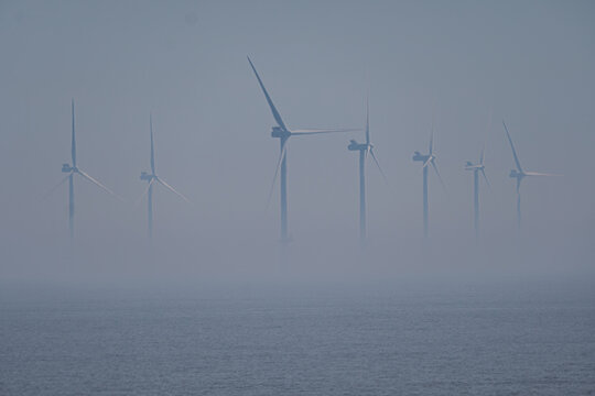 Spurn Point Wind Turbines &mdash; Offshore Energy Structures in Coastal Mist Under Pale Sky