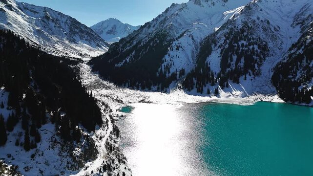 Aerial view of mountain lake at winter with snow