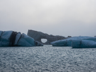 Icebergs floating in dense fog in Jokulsarlon Glacier Lagoon in Iceland