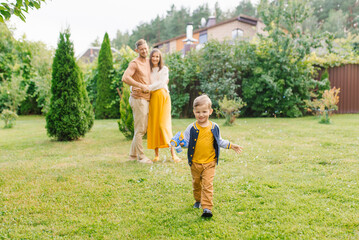 Obraz premium Happy Child Running With Bubble Gun Outdoors