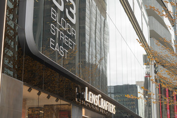 Fototapeta premium exterior of 33 Bloor St E and sign of LensCrafters, an optometrist, Toronto