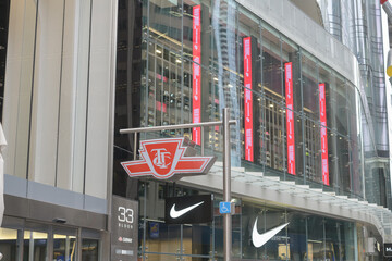 Fototapeta premium exterior of 33 Bloor St E, public transit subway entrance logo sign, and facade of Nike Bloor, Toronto