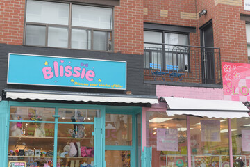 Fototapeta premium exterior of 78 and 80 Kensington Av with signs and merchandise, Toronto