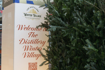 Fototapeta premium Winter Village sign with evergreens at The Distillery Historic District, Toronto