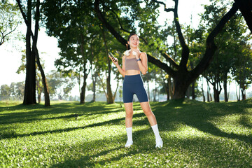 Woman enjoying music and nature during outdoor fitness workout