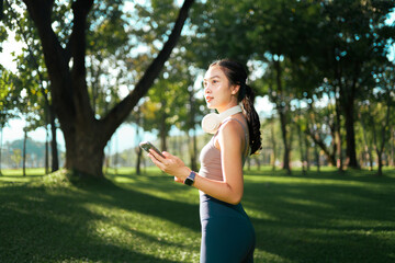 Young woman enjoying nature using phone in park