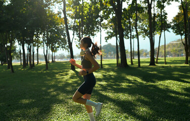 Woman running outdoors in park enjoying morning workout