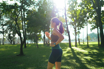 Young woman jogging in park enjoying morning workout