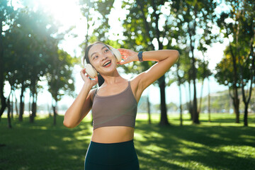 Young woman enjoying music outdoors during wellness activity