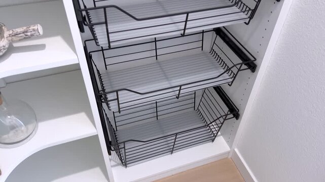 Empty pantry shelving with built in black wire baskets