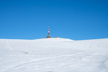 Radio tower on snow covered Costila Peak in Bucegi Mountains, Romania