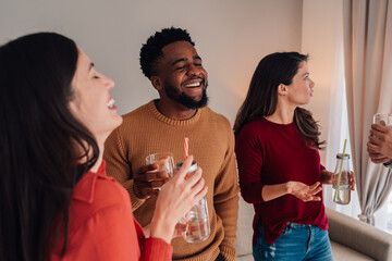 Diverse friends laughing and enjoying social gathering