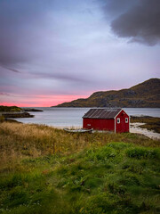 Red Fisherman&rsquo;s Cabin by a Norwegian Fjord at Peaceful Sunset