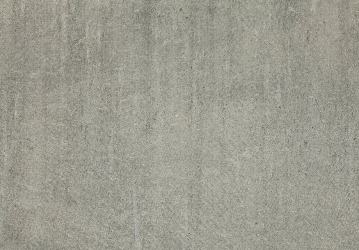 Gray cement wall, background. The texture of the old wall with streaks of the rain, darkened by old age. Asbestos slate fence. Portland cement covering, backdrop. Asbestos surface, faded in the sun