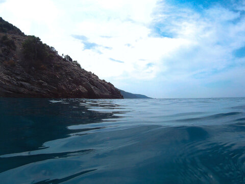 Rocky Shoreline and Calm Sea &mdash; Reflections, Blue Sky, and Coastal Stillness in Old&ouml;niz, Turkey
