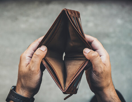 Hands holding an empty wallet symbolizing lack of money and financial stress