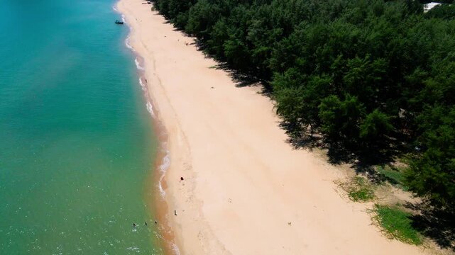 Aerial view of Pantai Bukit Keluang, Besut, Terengganu, showing turquoise waters, coastal cliffs, and clear sunny skies along the scenic shoreline.