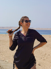 portrait of young woman in sunglasses on the beach in Red Sea Egypt
